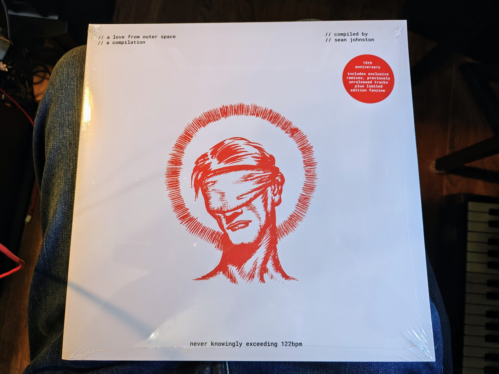 A record: the A Love from Outer Space compilation, the logo for which is a drawing of a man wearing a blindfold 