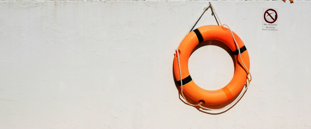 A life preserver ring against a wall