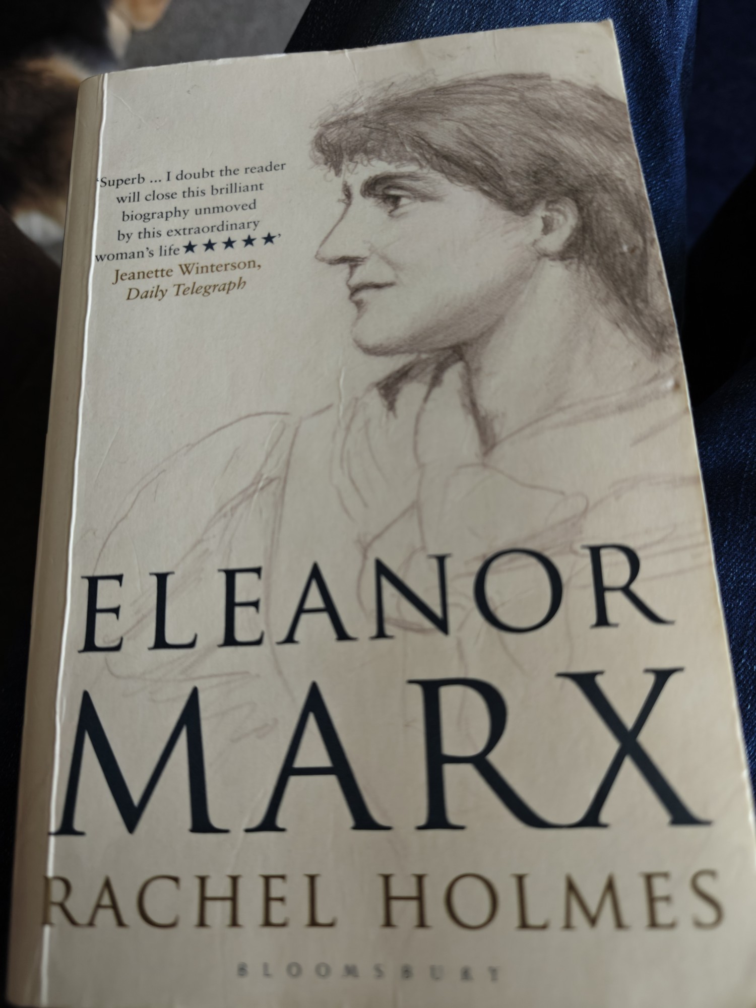 The front cover of Eleanor Marx by Rachel Holmes. It's a cream cover with the text at the bottom and a drawing of Eleanor Marx at the top looking towards the left 