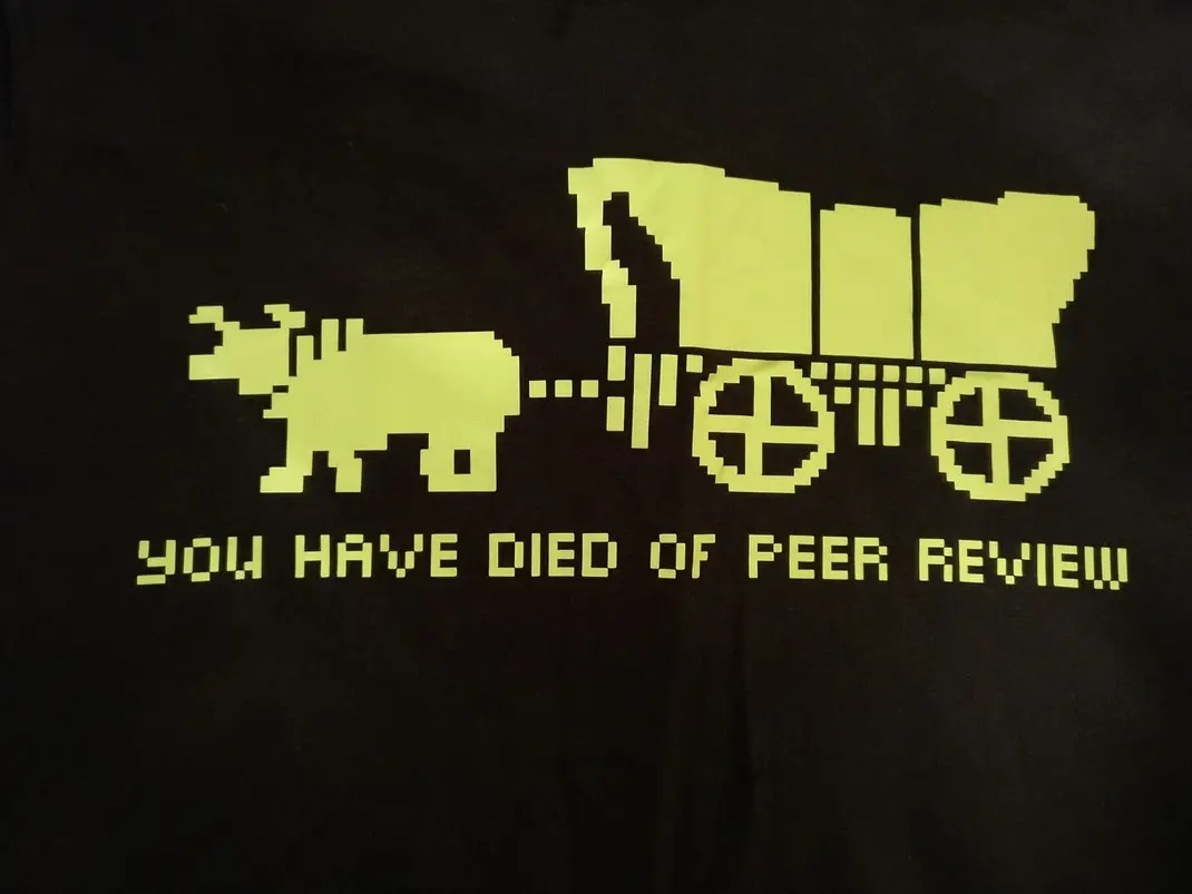 A picture of the wagon image from The Oregon Trail that says "you have died of peer review". 