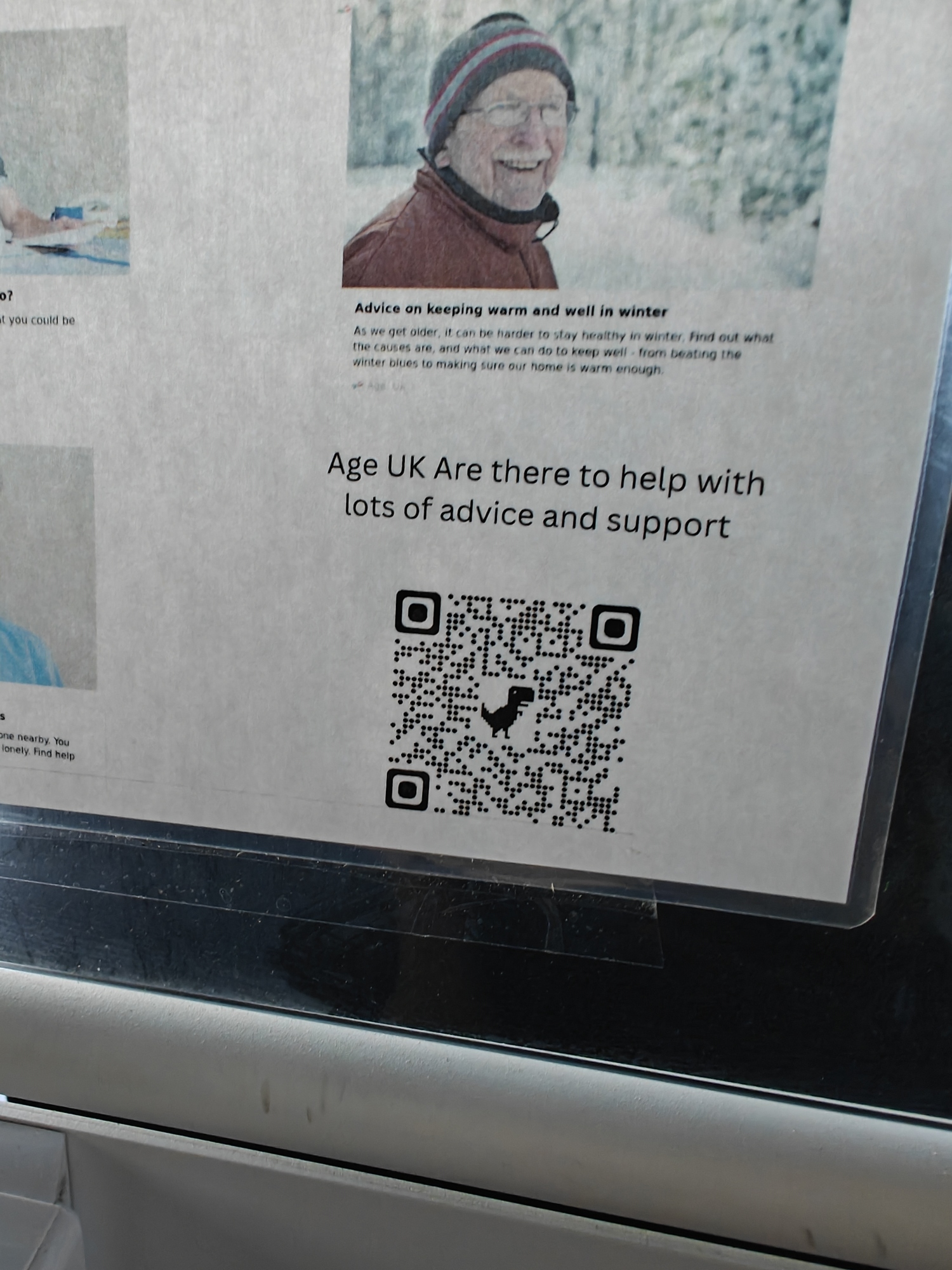 A QR code for Age UK with a dinosaur in the middle 