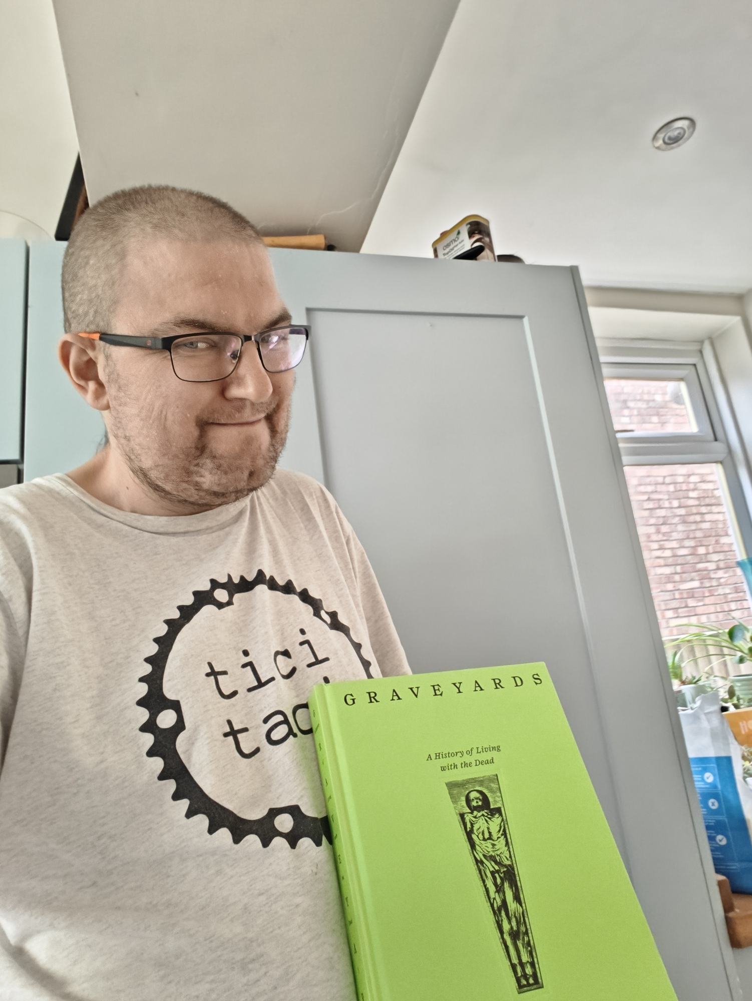 A picture of me with Roger Luckhurst's book, Graveyards 