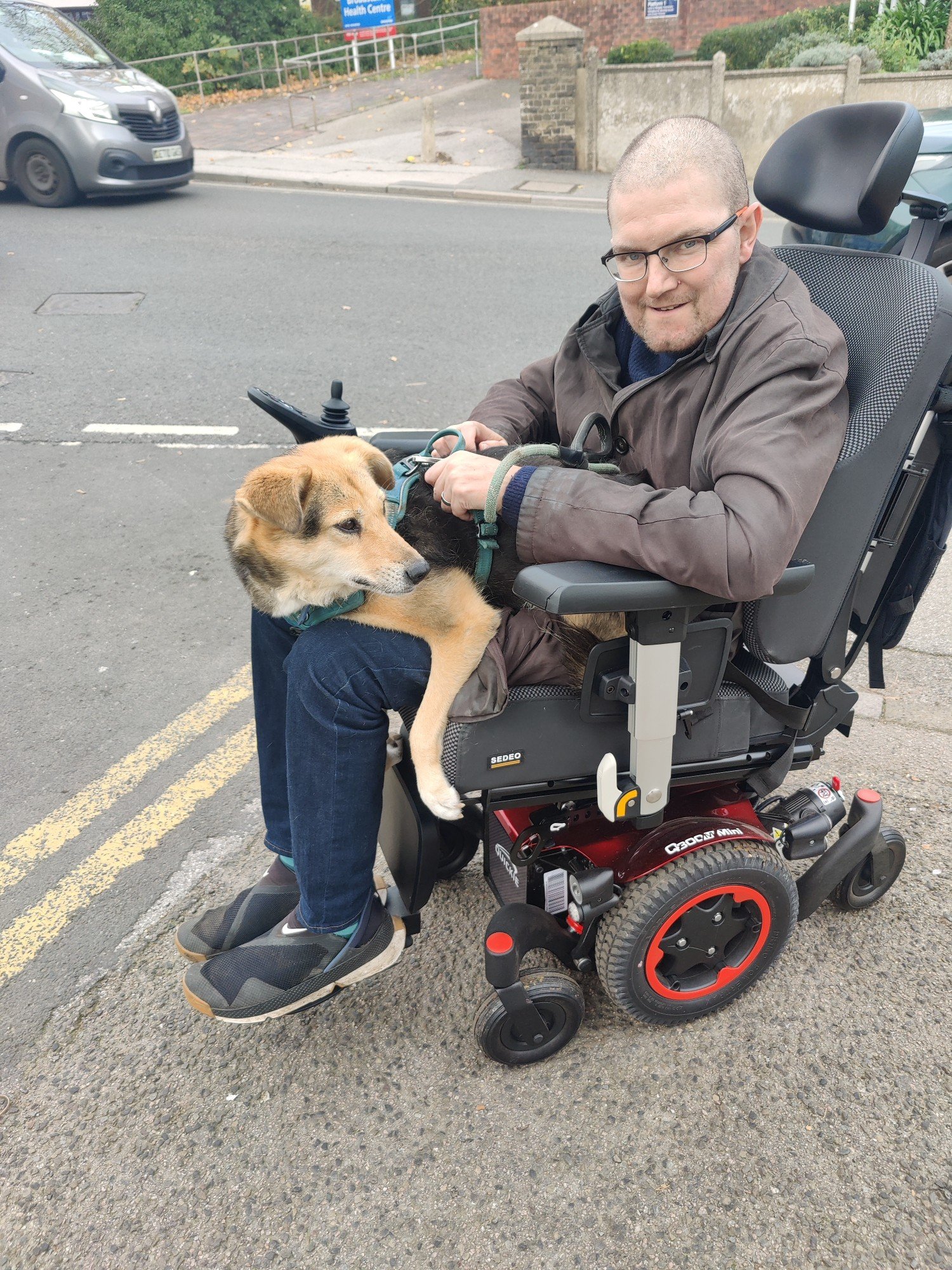 The same dog on a motorized wheelchair with me