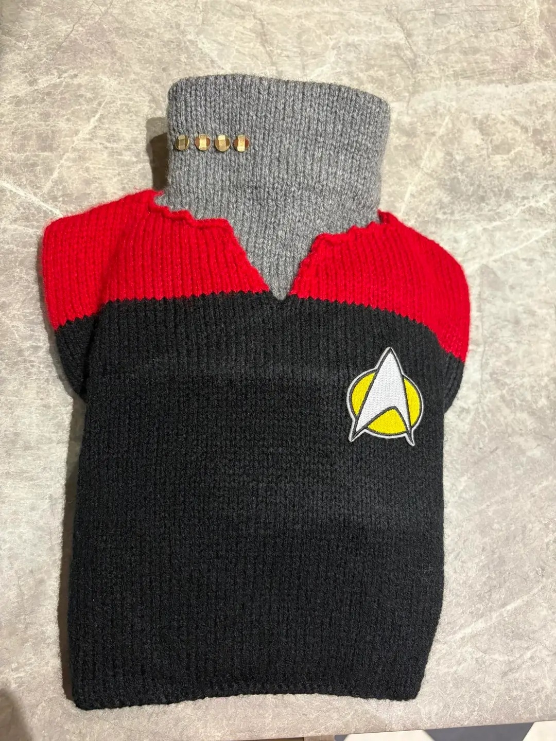 A hot water bottle cover that looks like the Star Trek uniforms. It's a red top with some pips on the "neck" 