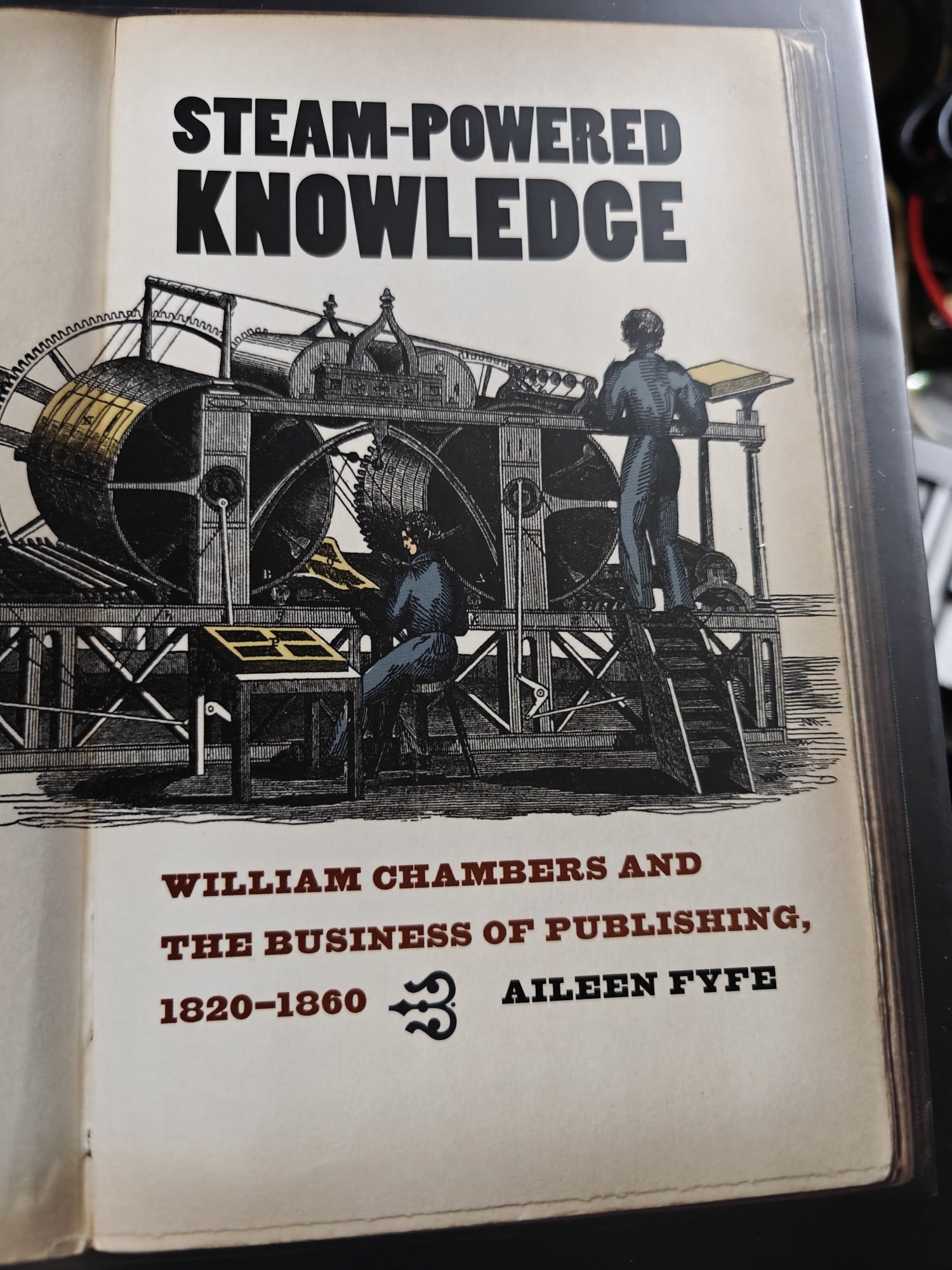 A copy of Aileen Fyfe's Steam-Powered Knowledge. It features a large mechanical printing press on the cover. 