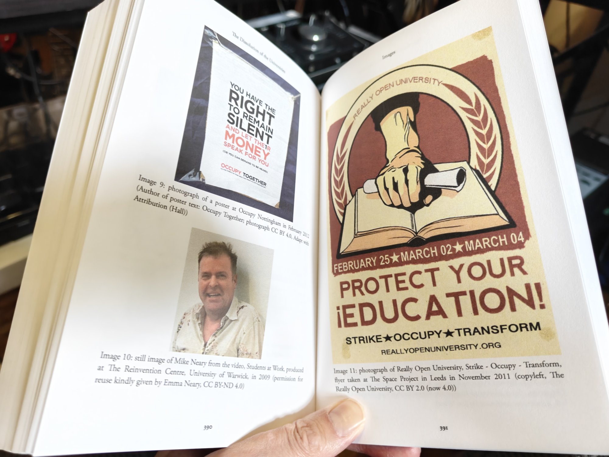 A page spread inside Richard Hall's The Dissolution of the Universities. It shows a picture of our much loved ex-colleague Mike Neary with two educational posters. One is for the Really Open University and has a soviet style feel to it with a hand reaching down to a book, holding a scroll. The other is a more plain white poster with black and red text decrying the influence of money on the university. 