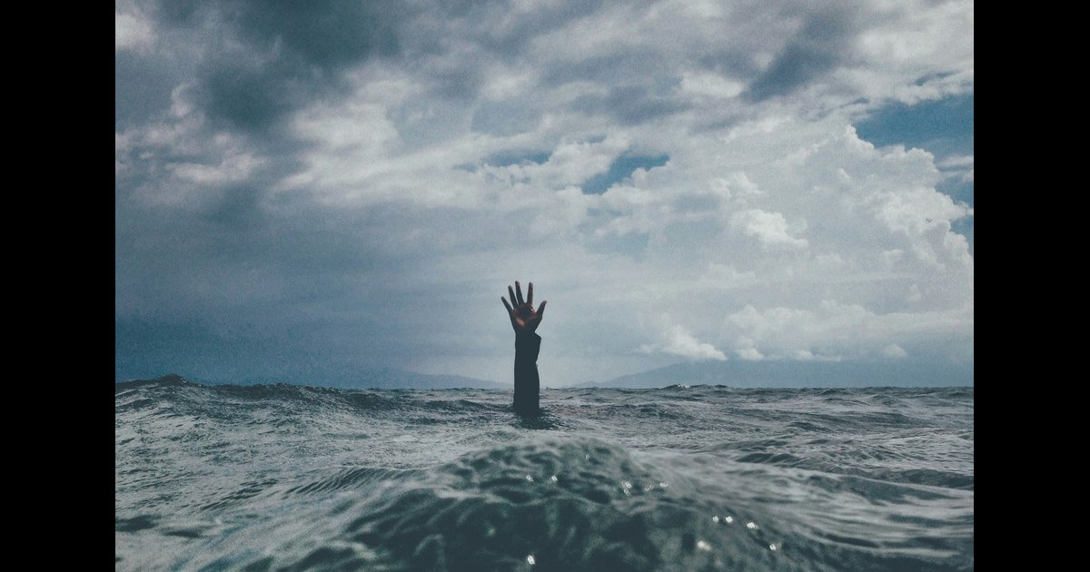 An abstract image representing pain; it shows a hand coming up out of some water