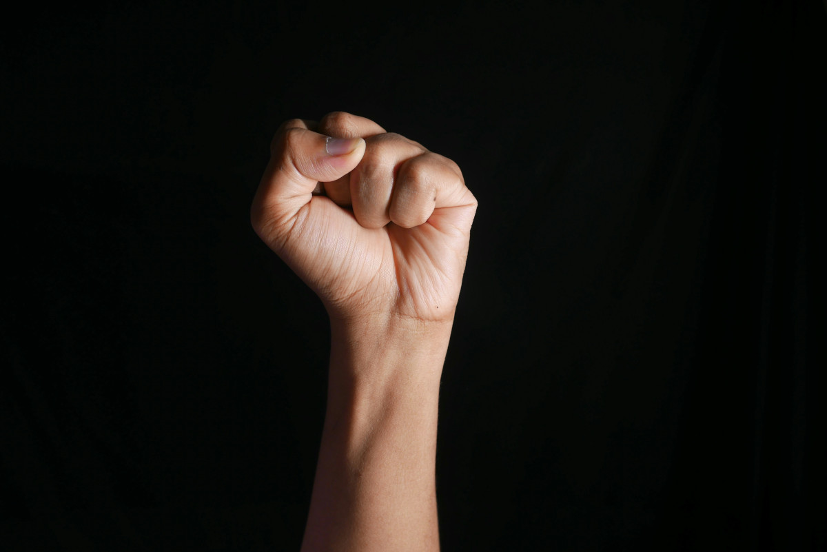 A clenched fist raised in resistance